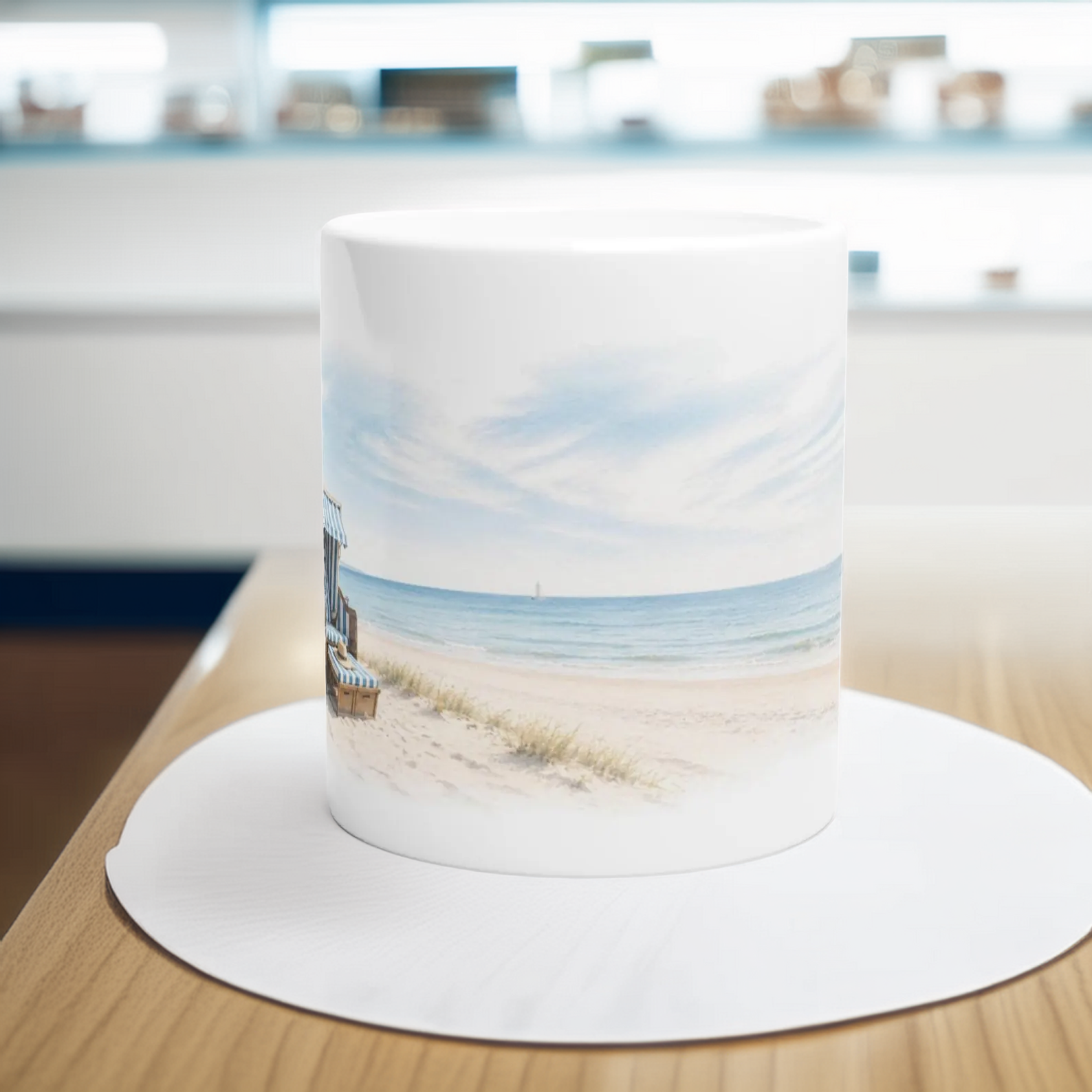 Keramiktasse mit umlaufendem Strandmotiv aus Meer, Dünen, Himmel und einem klassischen Strandkorb.