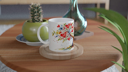 Geschenktasse mit verliebtem Vogelpaar an einem Baum mit Herzen. Der zarte Aquarellstil macht die Keramiktasse zu einer romantischen Aufmerksamkeit für einen Lieblingsmenschen.